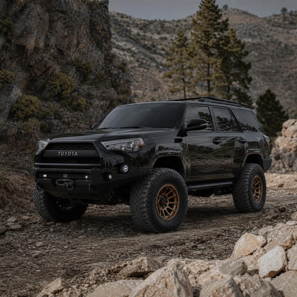 Lifted Toyota 4Runner with a roof rack on an open dirt track