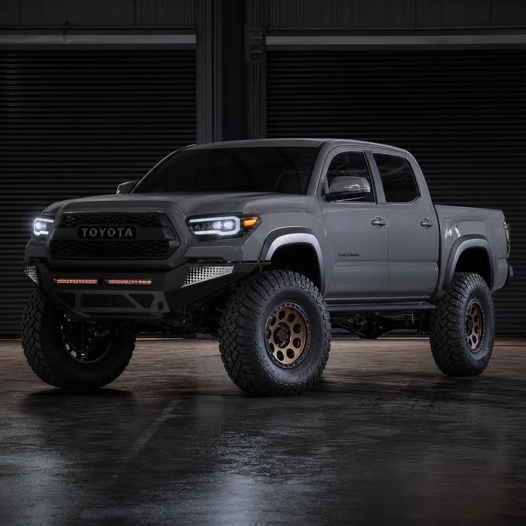 Lifted Toyota Tacoma on a dusty trail in warm low sun